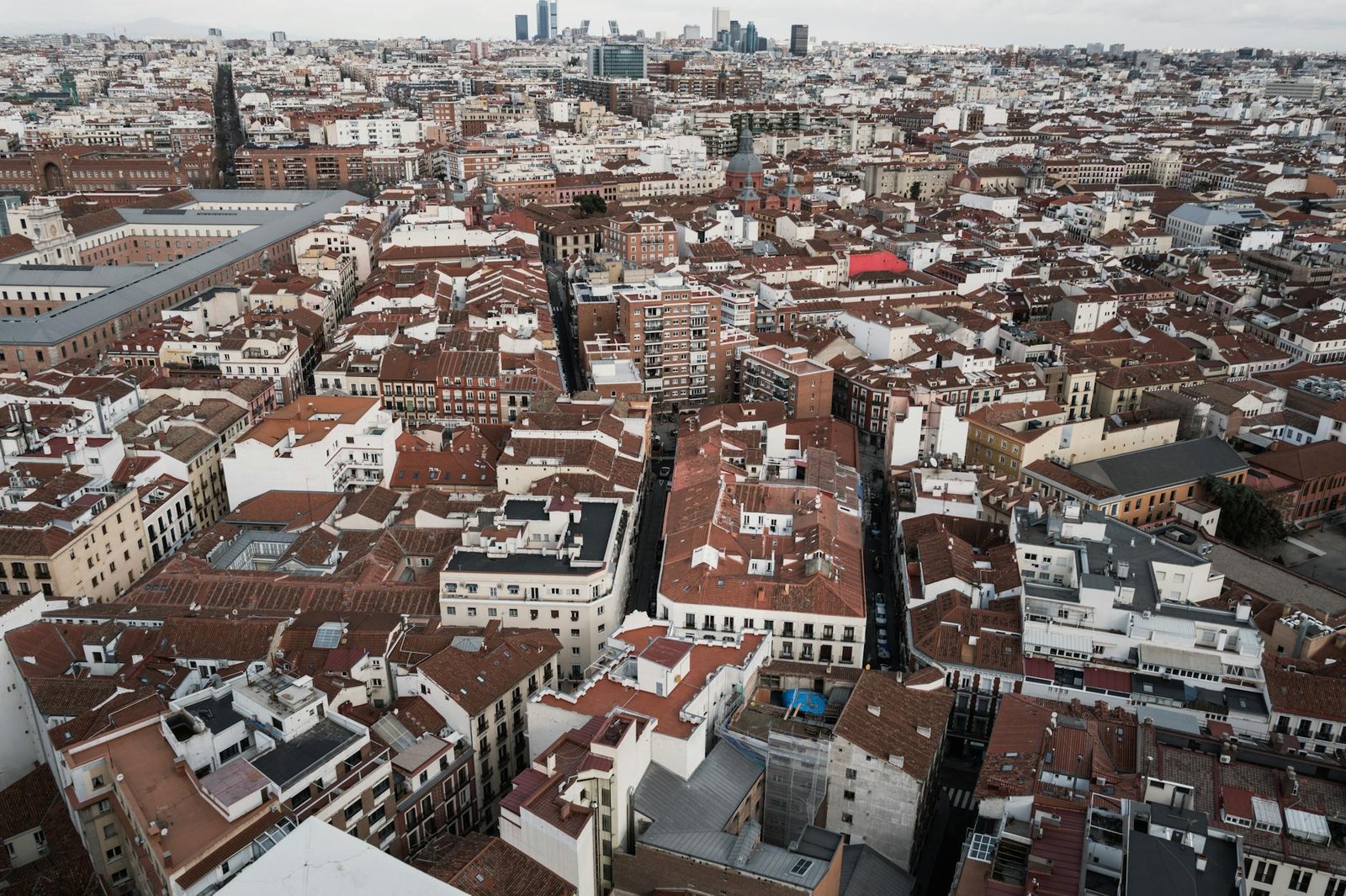 Aerial shot of Madrid's red-tiled rooftops and dense urban landscape, Spain.