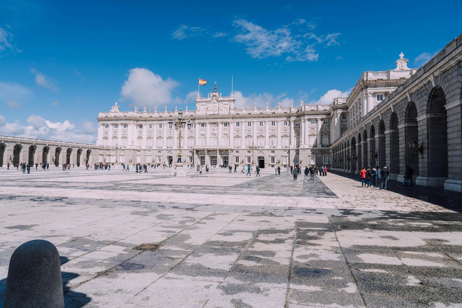 The iconic Royal Palace of Madrid under a clear blue sky.