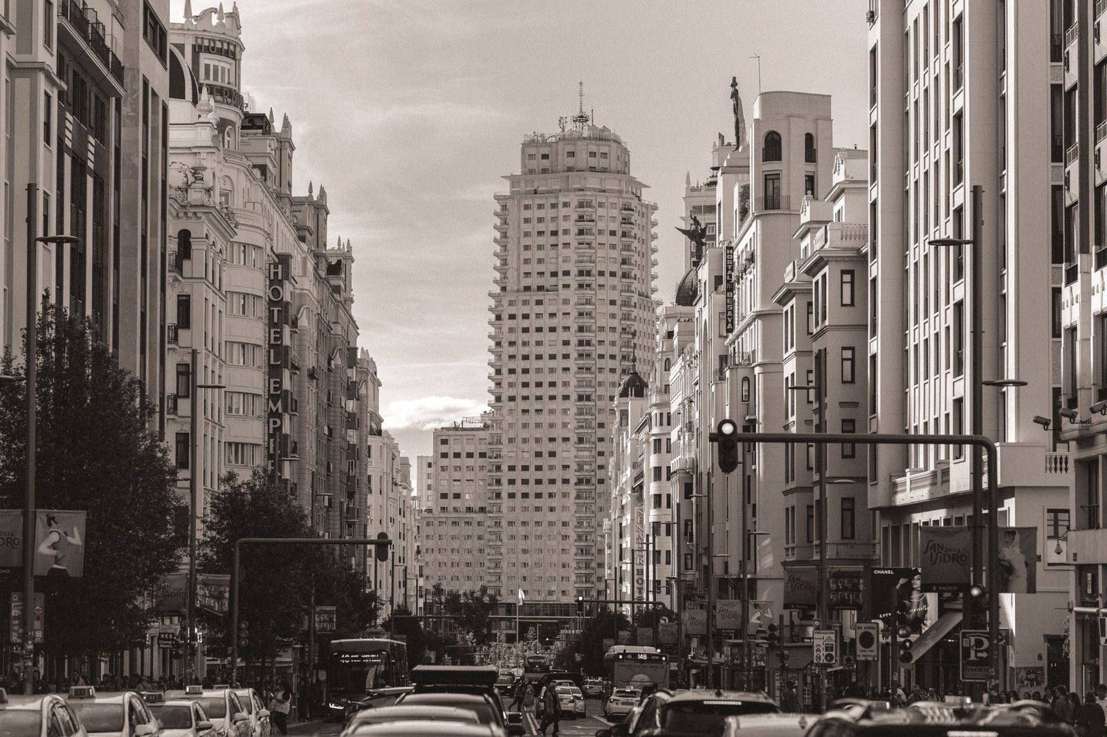Classic view of Madrid's bustling Gran Vía street showcasing iconic architecture and traffic.