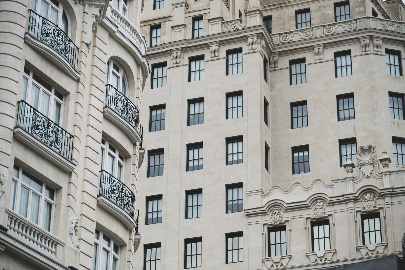 An elegant European-style building facade featuring intricate ironwork and detailed stonework.