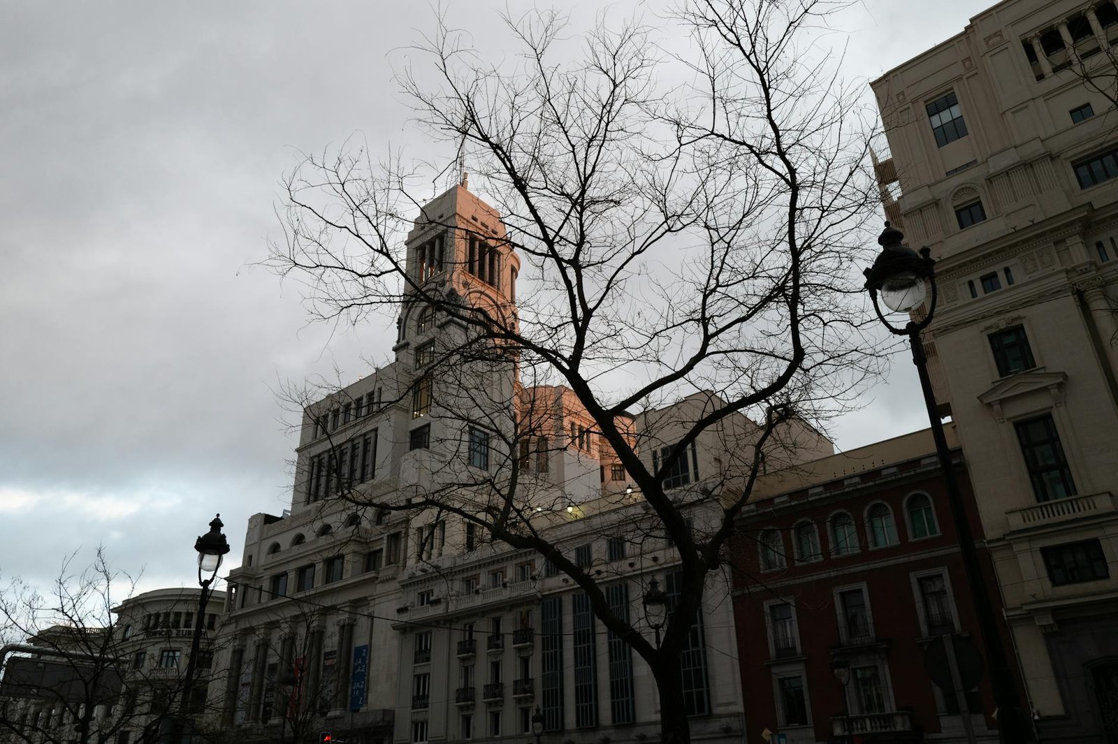 Dramatic skyline with historical architecture in Madrid during sunset.
